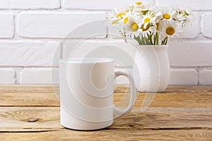 White coffee mug mockup with chamomile bouquet in rustic vase