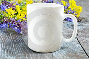 White coffee mug mockup with lilac and yellow flowers