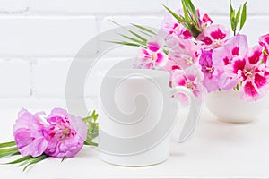 White coffee mug mockup with pink godetia flowers photo