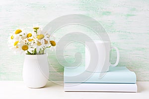 White coffee mug mockup with white field chamomile bouquet in ha