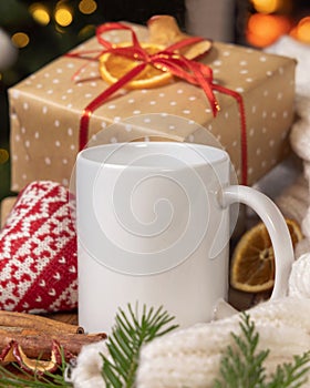 White coffee mug near Christmas present, cosy heart and sweater, winter mockup