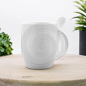 White coffee mug and spoon on backdrops. Ceramic tea cup for your design