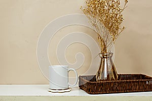 white coffee mug , white porcelain mug mock up on wood table with gypsophila flowers vase.