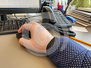 White collar work - man working with desktop computer in office closeup of hand clicking mouse