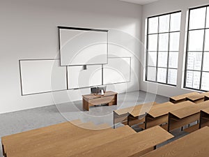 White college classroom corner with projection screen and whiteboards