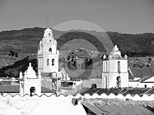 White colonial bell towers and orange rooftops in Sucre, Bolivia, South America