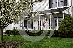 White colonial house with white picket fence