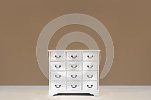 The white color dresser with many drawers