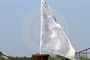 White color flag made of cloth display under bright daylight.