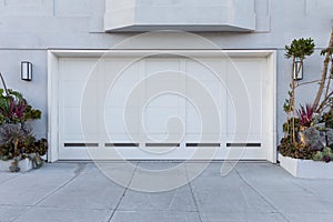 A white color garage door that fits two cars photo