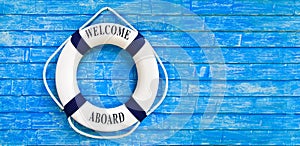 White color Life buoyancy with welcome aboard on it hanging on b photo