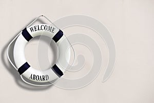 White color Life buoyancy with welcome aboard on it hanging on w