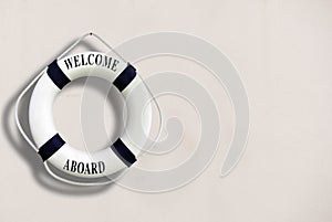 White color Life buoyancy with welcome aboard on it hanging on w photo