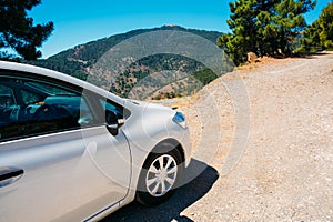 White color small hatchback car on Spainish nature