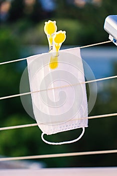 White color surgical mask on laundry string