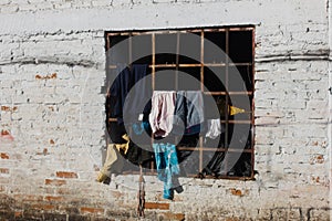 white colored window with clothes of latinos receiving the sun in colombia