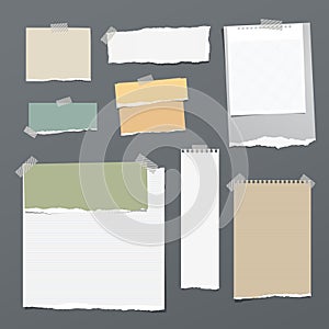 White and colorful striped note paper, copybook, notebook sheet stuck with adhesive tape on dark gray background.