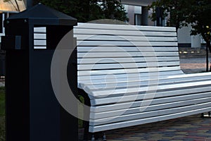 White comfortable park bench on summer evening