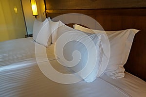 white comfy pillows on double bed in luxury hotel bedroom