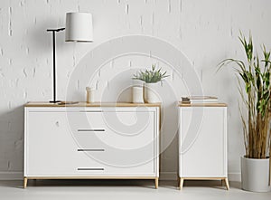 White commode with table lamp in bright minimalism interior style