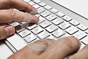 White computer keyboard with hands