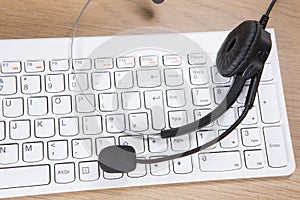 White computer keyboard with headset