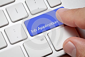 Male hand pressing computer keyboard job application button