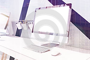 White computer screen on a desk toned