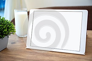 White computer tablet with isolated screen on table in cafe