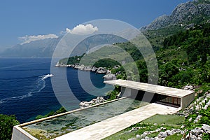 White Concrete Housess Near Sea Under Blue Sky