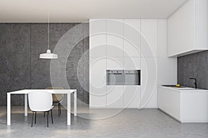 White and concrete kitchen with table