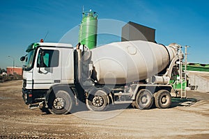 White concrete mixer vehicle on the construction site