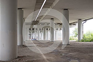 White concrete pillars of the bridge. bottom view of the bridge