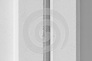 White concrete wall with reinforced post