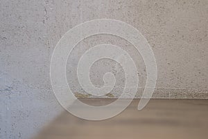 White concrete wall with wooden shelf unfocus