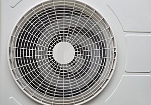 White conditioner compressor fan front view at home