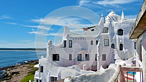 White construction with the blue sky and the beach on background. Casapueblo