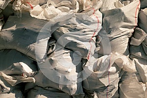 White construction garbage bags. Construction garbage bags piled on top of one another. A large pile of construction garbage bags