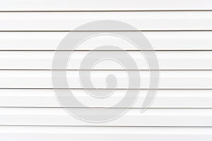 White construction vinyl siding panels. House covered with plastic vinyl siding. Vinyl siding wall surface with horizontal lines.