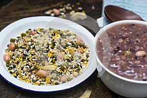 White container holding raw materials of eight treasures porridge on a wooden board