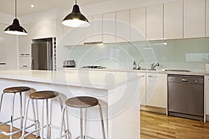 White contemporary kitchen with island photo
