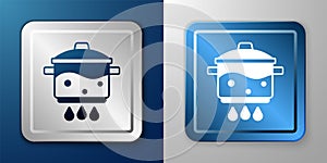 White Cooking pot on fire icon isolated on blue and grey background. Boil or stew food symbol. Silver and blue square