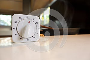 White cooking timer countdown on the white table in the asia modern kitchen photo