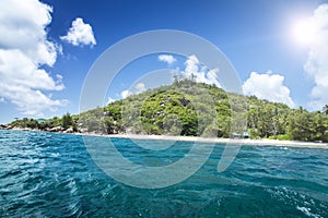 White coral sand on tropical beach. La Digue island, Seyshelles.