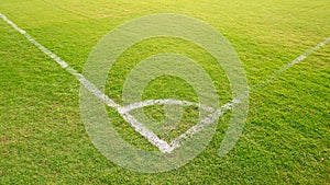 White Corner line on green lawn of soccer (football) field