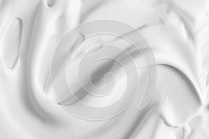 White cosmetic foam texture background. Cosmetic mousse, cleanser, shaving foam, shampoo. Foamy skin care product