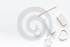 White cosmetic set on desk background top view mock up