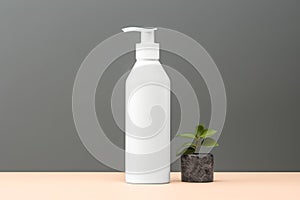 White cosmetic shampoo dispenser bottle mockup and stone with plant on gray background.