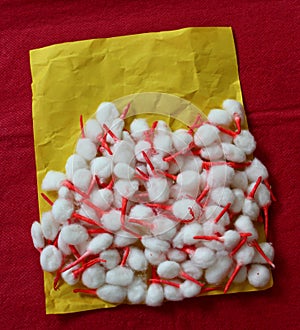 White cotton diya wicks kept on yellow paper