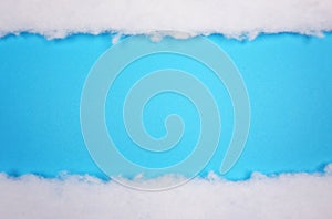 White cotton texture snow blanket, is soft, fluffy wadding, cotton at blue background with copy space for your own text